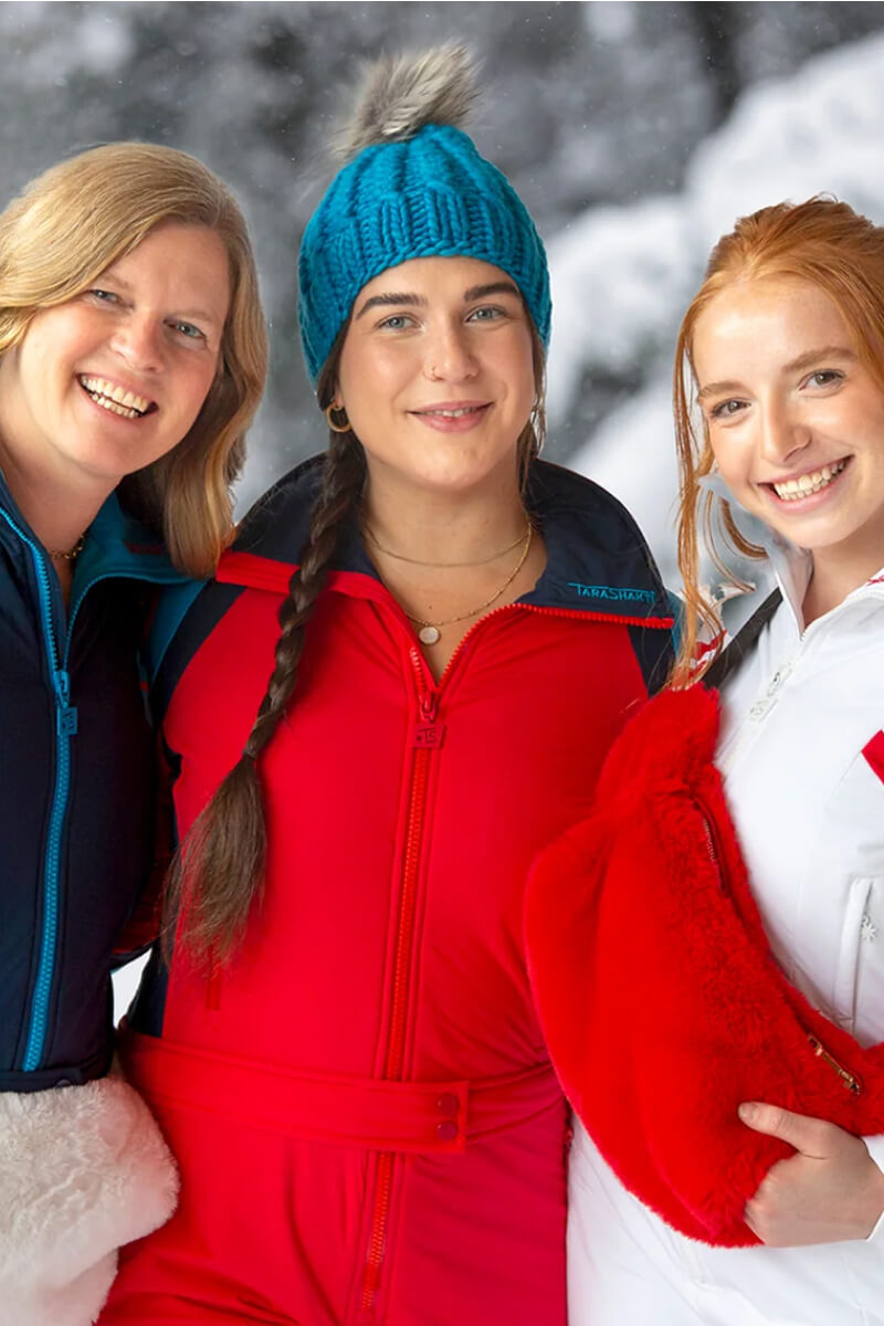 happy women wearing designer Tara Shakti snow suits beanies faux fur fanny pack