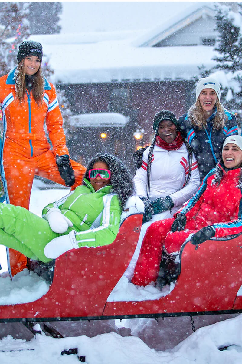 happy women wearing designer Tara Shakti snow suits