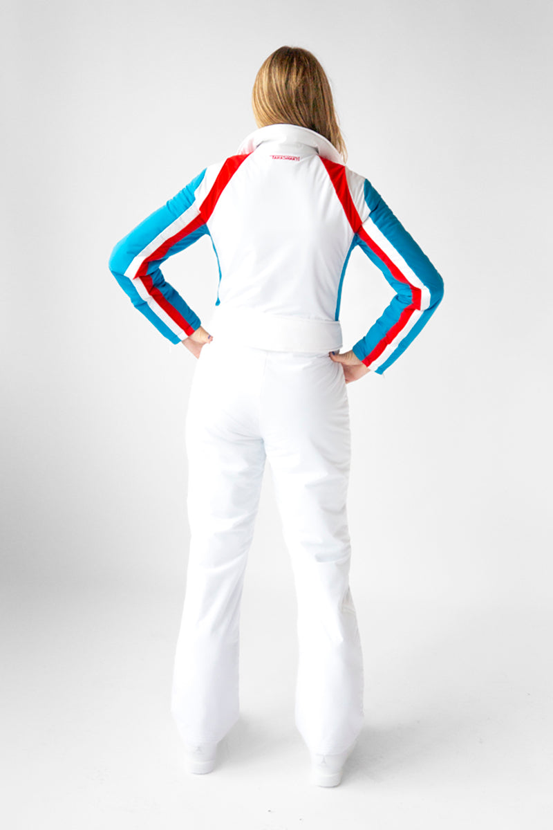 back view model wearing tara shakti one-piece ski suit Brandy variant white red light blue