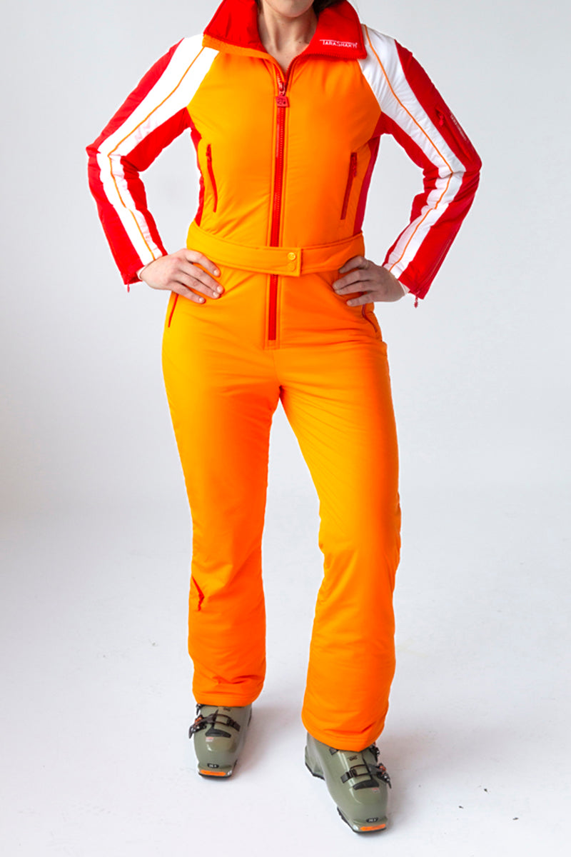 front view model wearing tara shakti one-piece ski suit stevie variant orange red white (7313803182264)