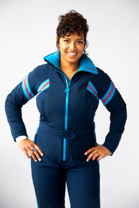 front closeup view model wearing tara shakti one-piece ski suit bonnie variant dark and light blue