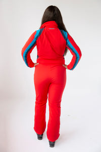 back view model wearing tara shakti one-piece ski suit Diana variant red light and dark blue