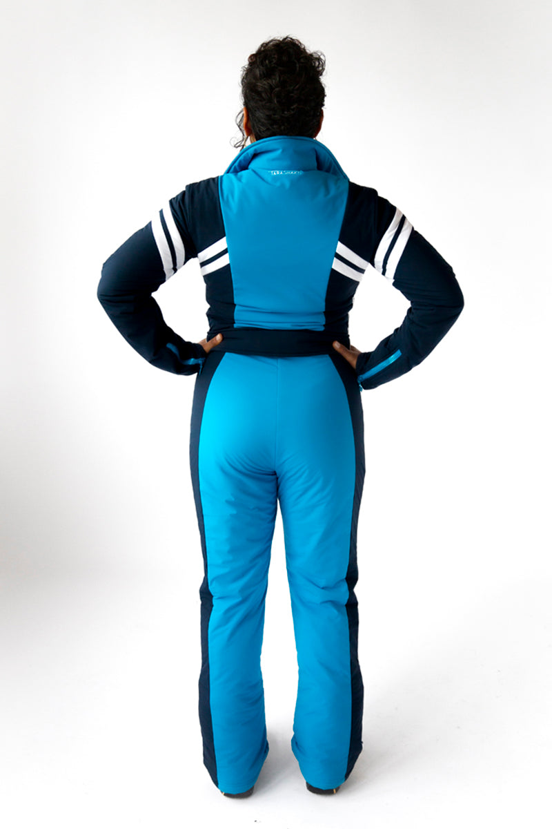 back view model wearing tara shakti one-piece ski suit Dylan variant light and dark blue (7313802690744)