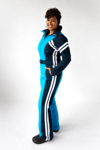 side view model wearing tara shakti one-piece ski suit Dylan variant light and dark blue (7313802690744)