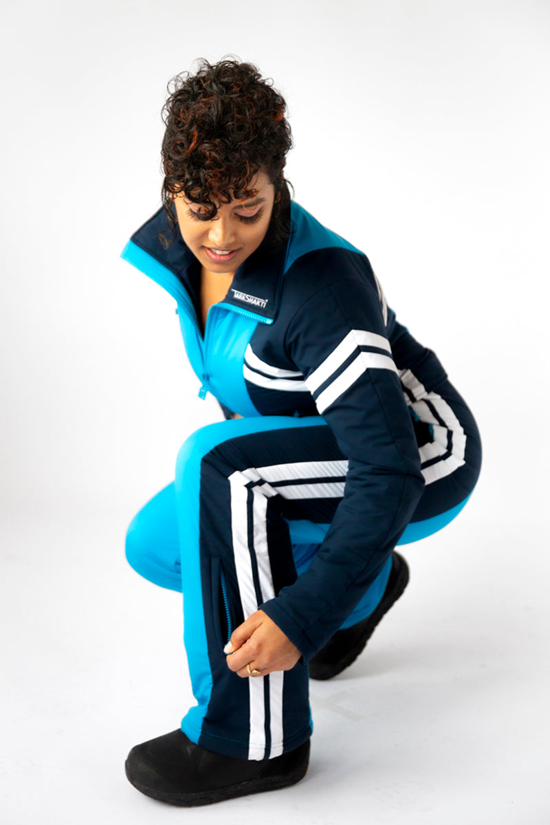 side squat view model wearing tara shakti one-piece ski suit Dylan variant light and dark blue (7313802690744)