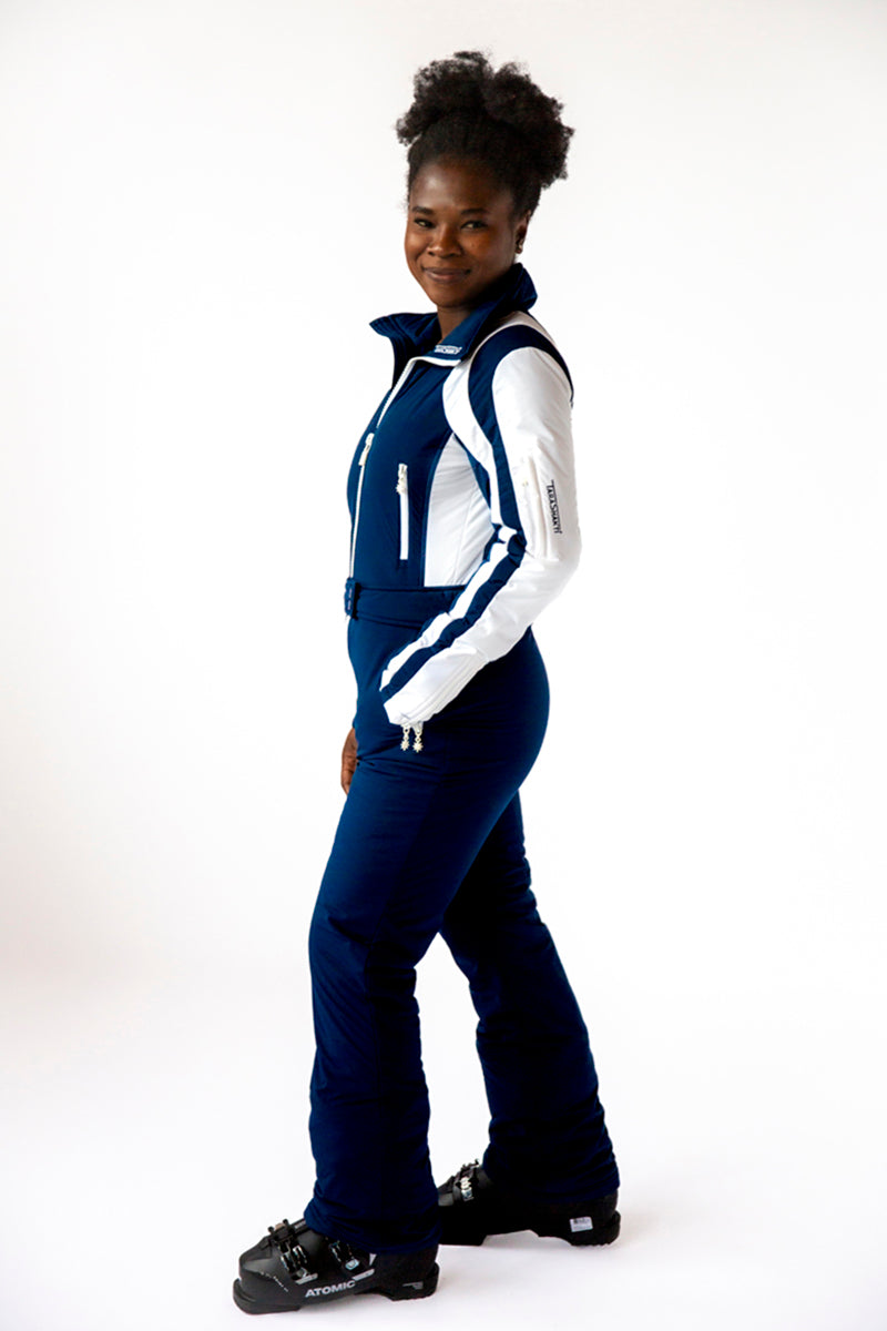 side view model wearing tara shakti one-piece ski suit Raquel variant white dark blue (7313802821816)