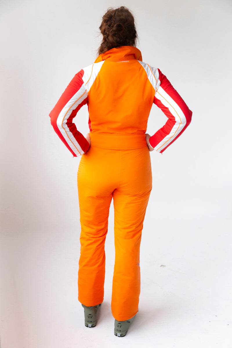 back view model wearing tara shakti one-piece ski suit stevie variant orange red white (7313803182264)