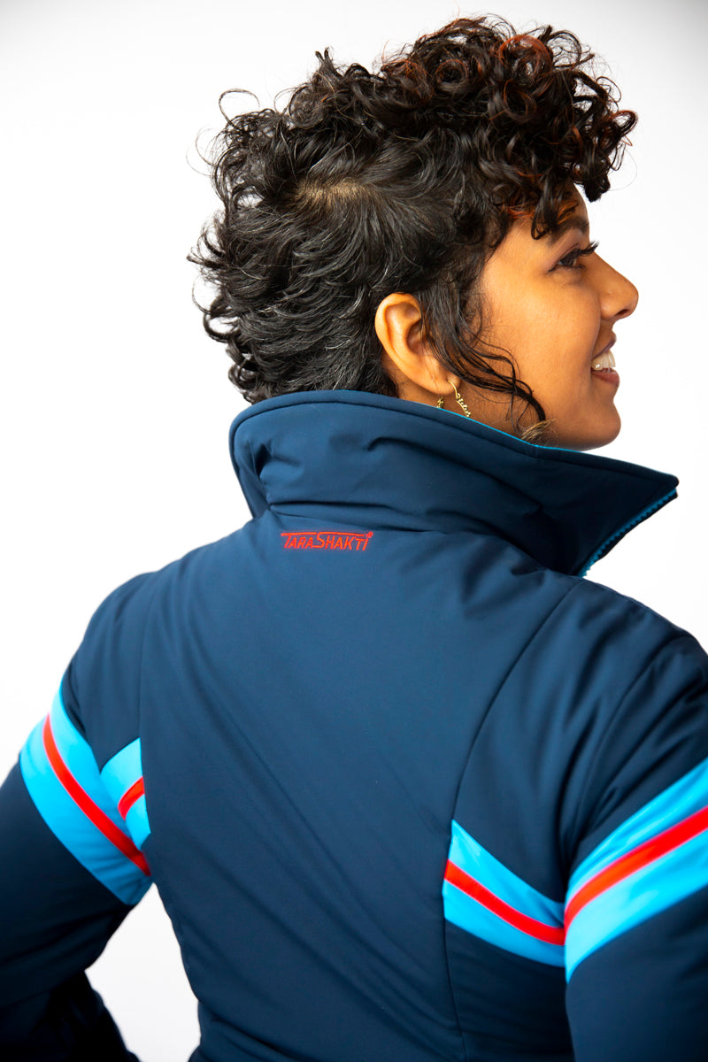 back closeup view model wearing tara shakti one-piece ski suit bonnie variant dark and light blue (7232644907192)