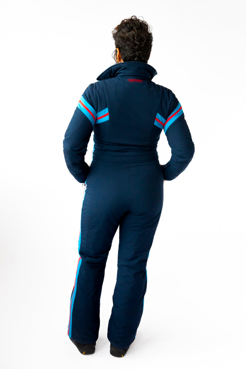 back view model wearing tara shakti one-piece ski suit bonnie variant dark and light blue