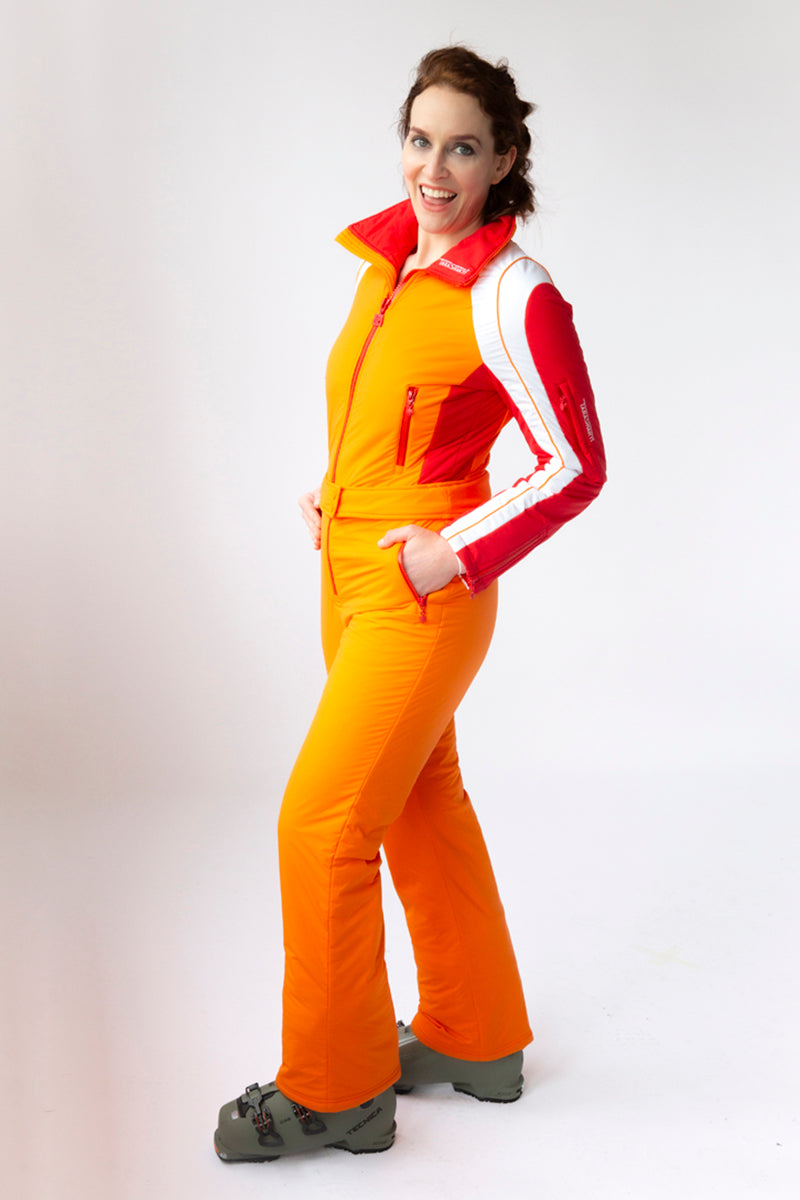 side view model wearing tara shakti one-piece ski suit stevie variant orange red white (7313803182264)